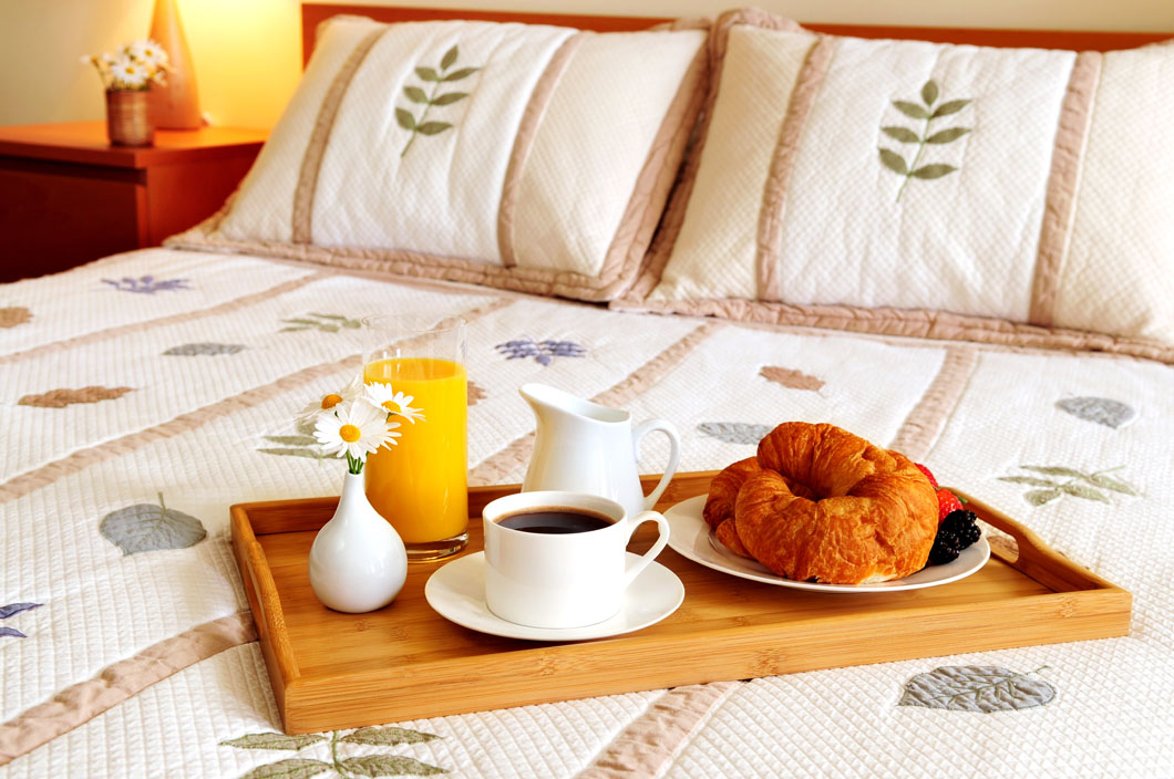 Breakfast On Bed In A Hotel Room a plate of food on a table